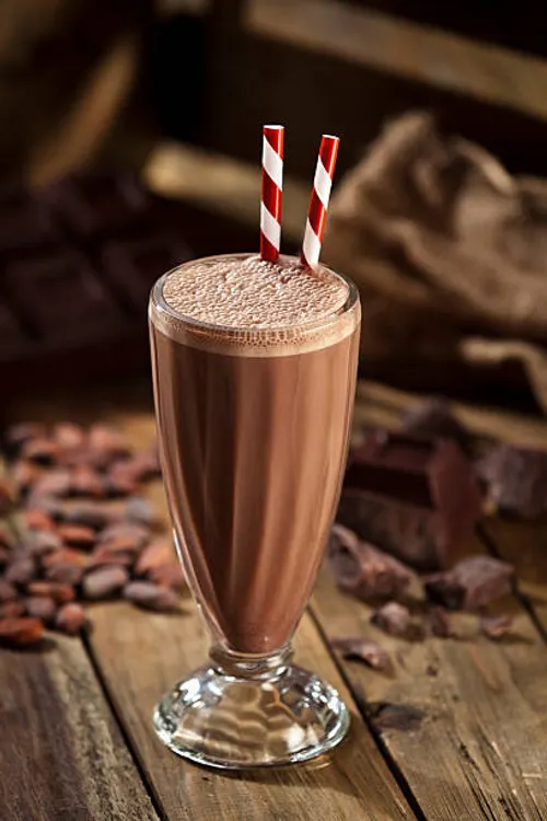 A chocolate milkshake with chocolate chunks.